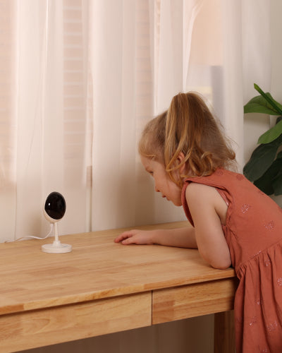 A little girl is looking at the Owltron Cam T1